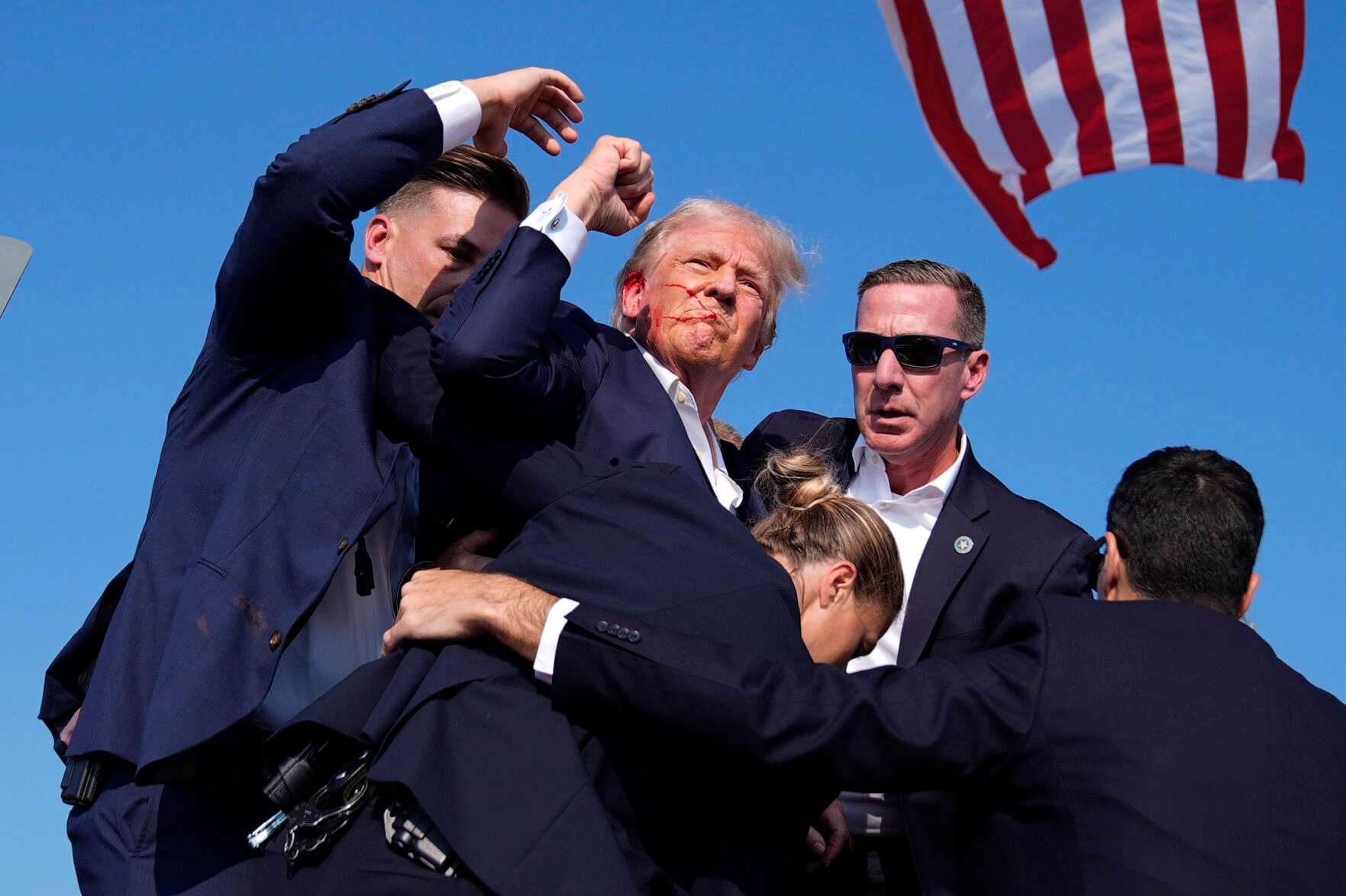 <p>Republican presidential candidate former President Donald Trump is surrounded by U.S. Secret Service agents Saturday at a campaign rally in Butler, Pa.</p>