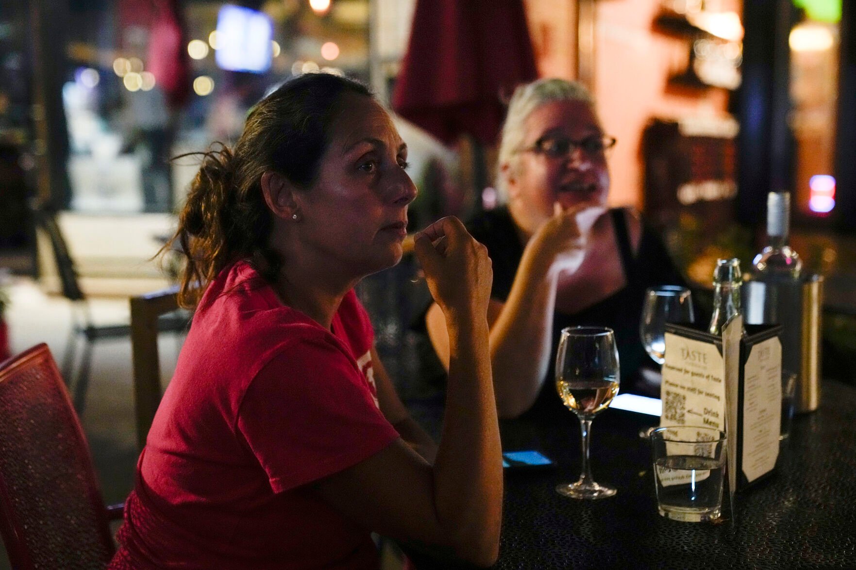 <p>Christine Bell, left, 56, and Tara Correia, 56, watch the presidential debate Tuesday between Republican presidential nominee former President Donald Trump and Democratic presidential nominee Vice President Kamala Harris at the Taste Food & Wine in the Rogers Park neighborhood of Chicago.</p>
