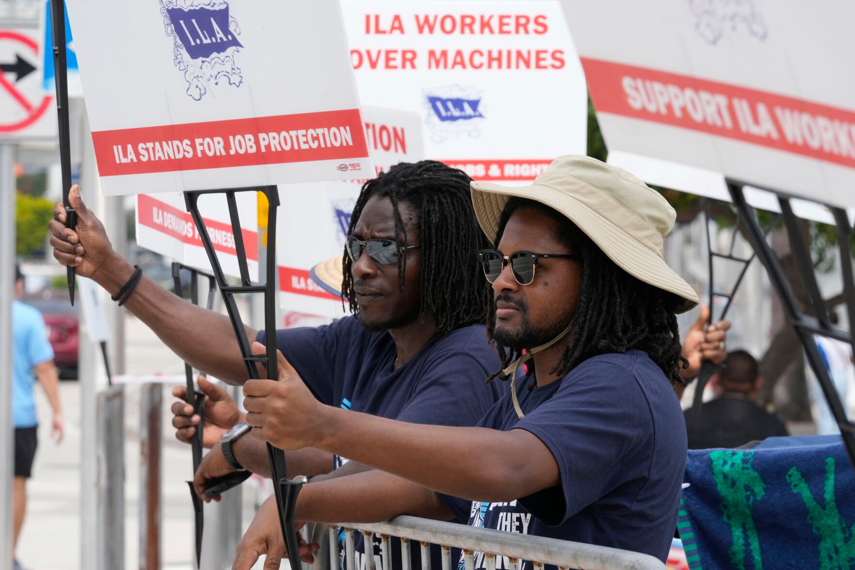<p>Dockworkers from Port Miami display signs at a picket line Thursday in Miami.</p>