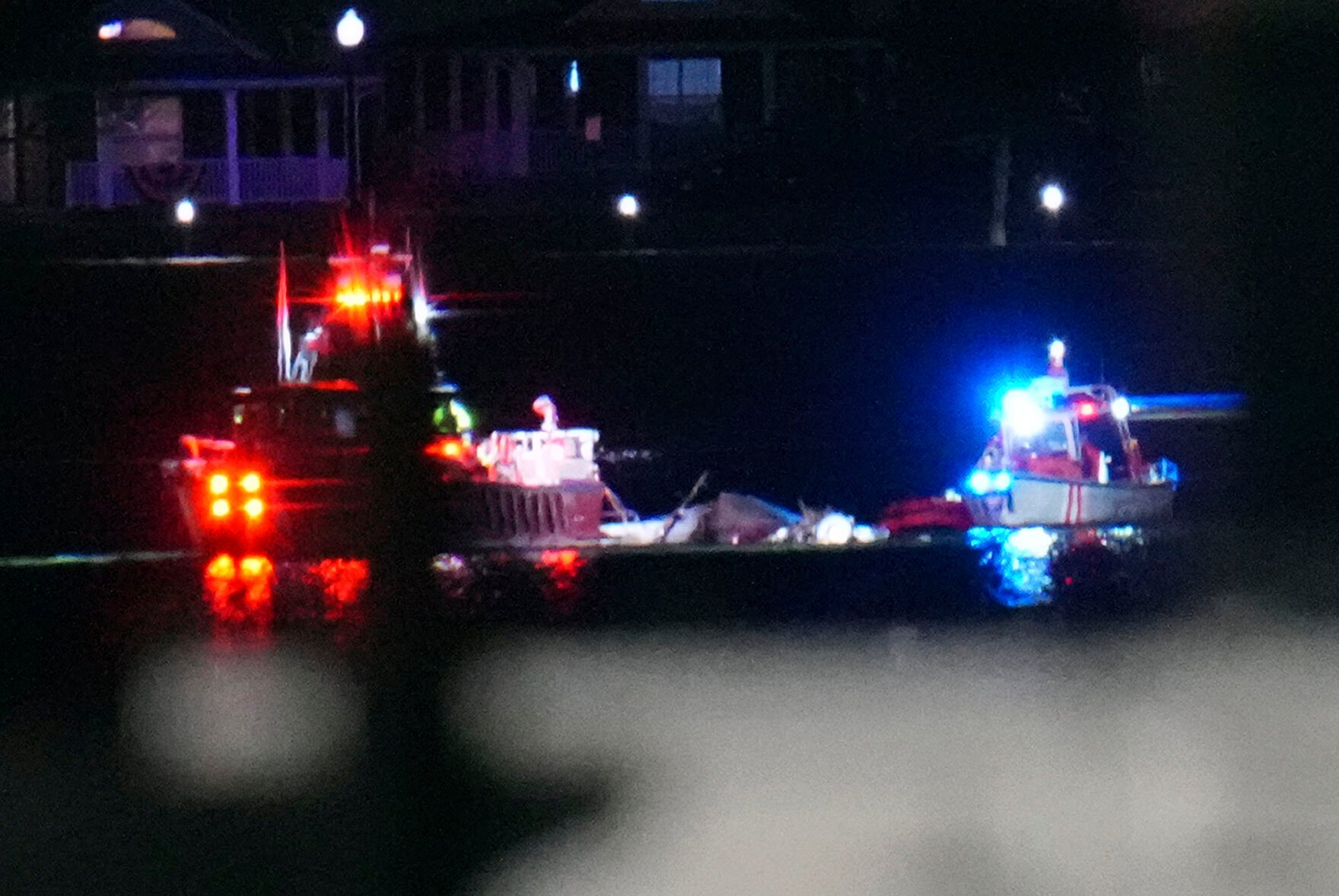 <p>Boats work the scene Wednesday night on the Potomac River near Ronald Reagan Washington National Airport in Arlington, Va.</p>