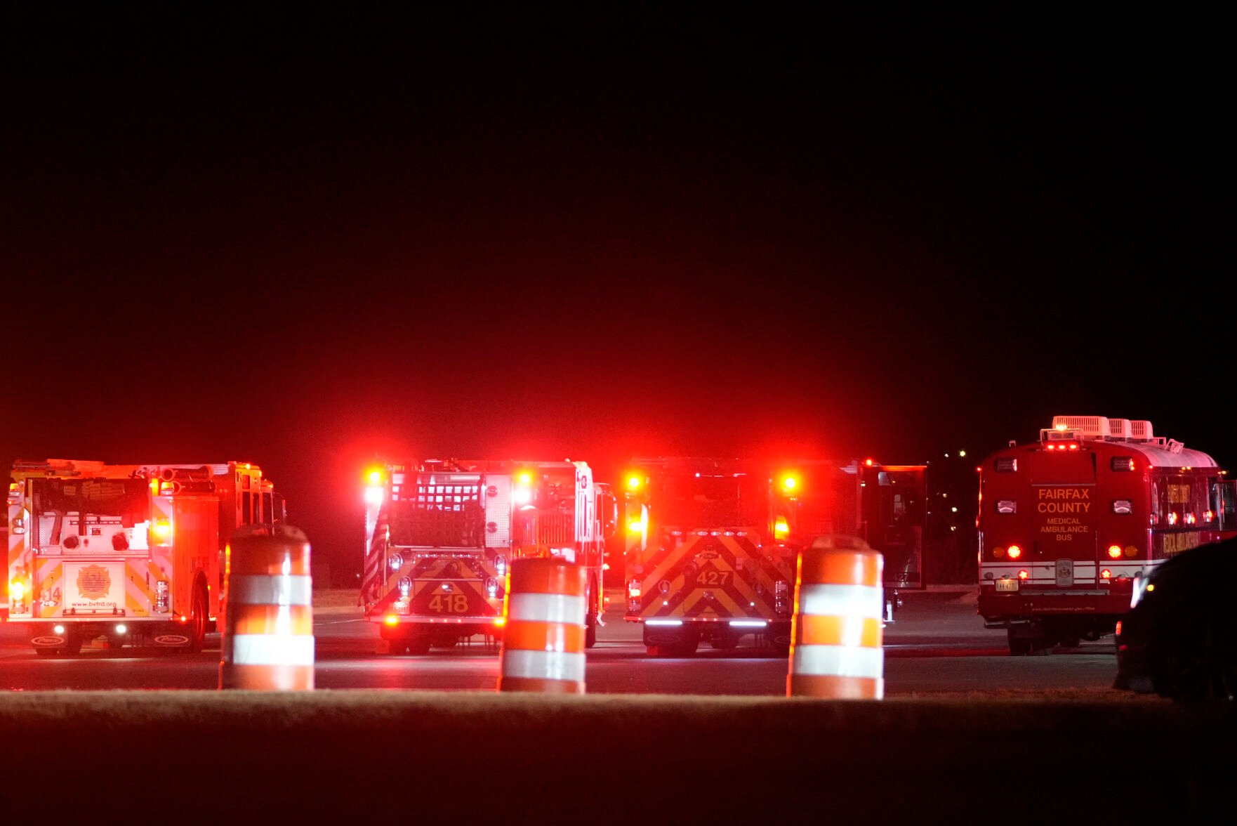 <p>Emergency vehicles stage Wednesday night at Gravelly Point along the Potomac River north of Ronald Reagan Washington National Airport in Arlington, Va.</p>