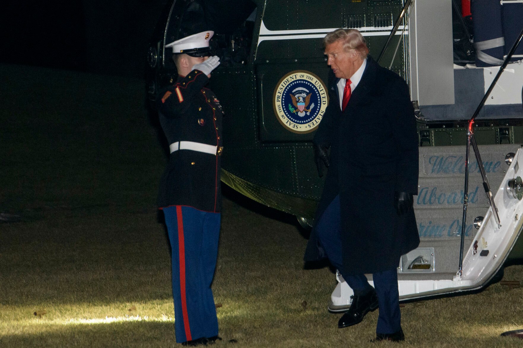 <p>President Donald Trump greets a Marine Corps honor guard Monday as he disembarks Marine One upon arrival on the South Lawn of the White House in Washington.</p>