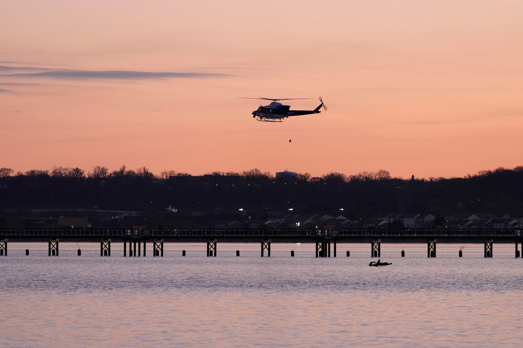<p>A helicopter flies over the Potomac River near Ronald Reagan Washington National Airport, Thursday, Jan. 30, 2025, in Arlington, Va. (AP Photo/Carolyn Kaster)</p>