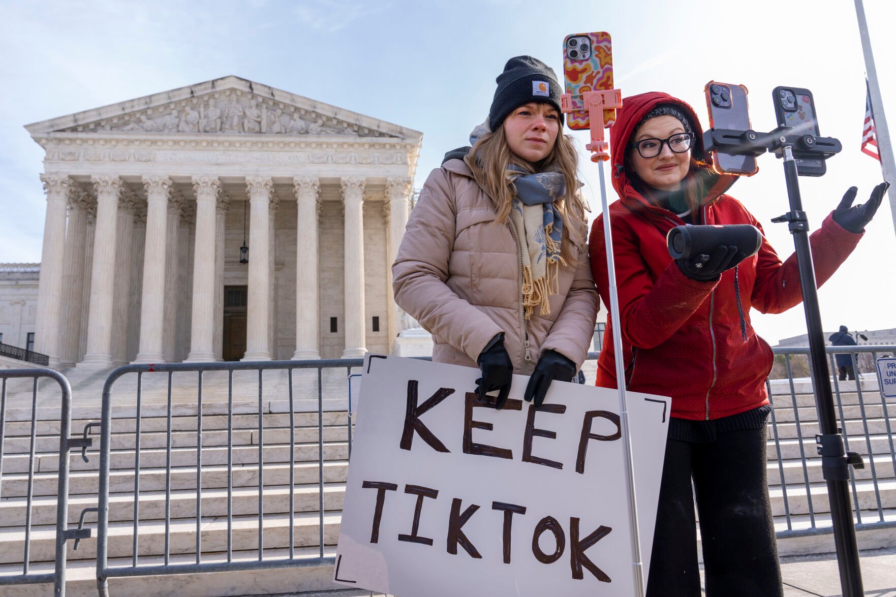 <p>FILE - Sarah Baus, left, of Charleston, S.C., and Tiffany Cianci, who says she is a "long-form educational content creator," livestream to TikTok outside the Supreme Court, on Jan. 10, 2025, in Washington. (AP Photo/Jacquelyn Martin, File)</p>