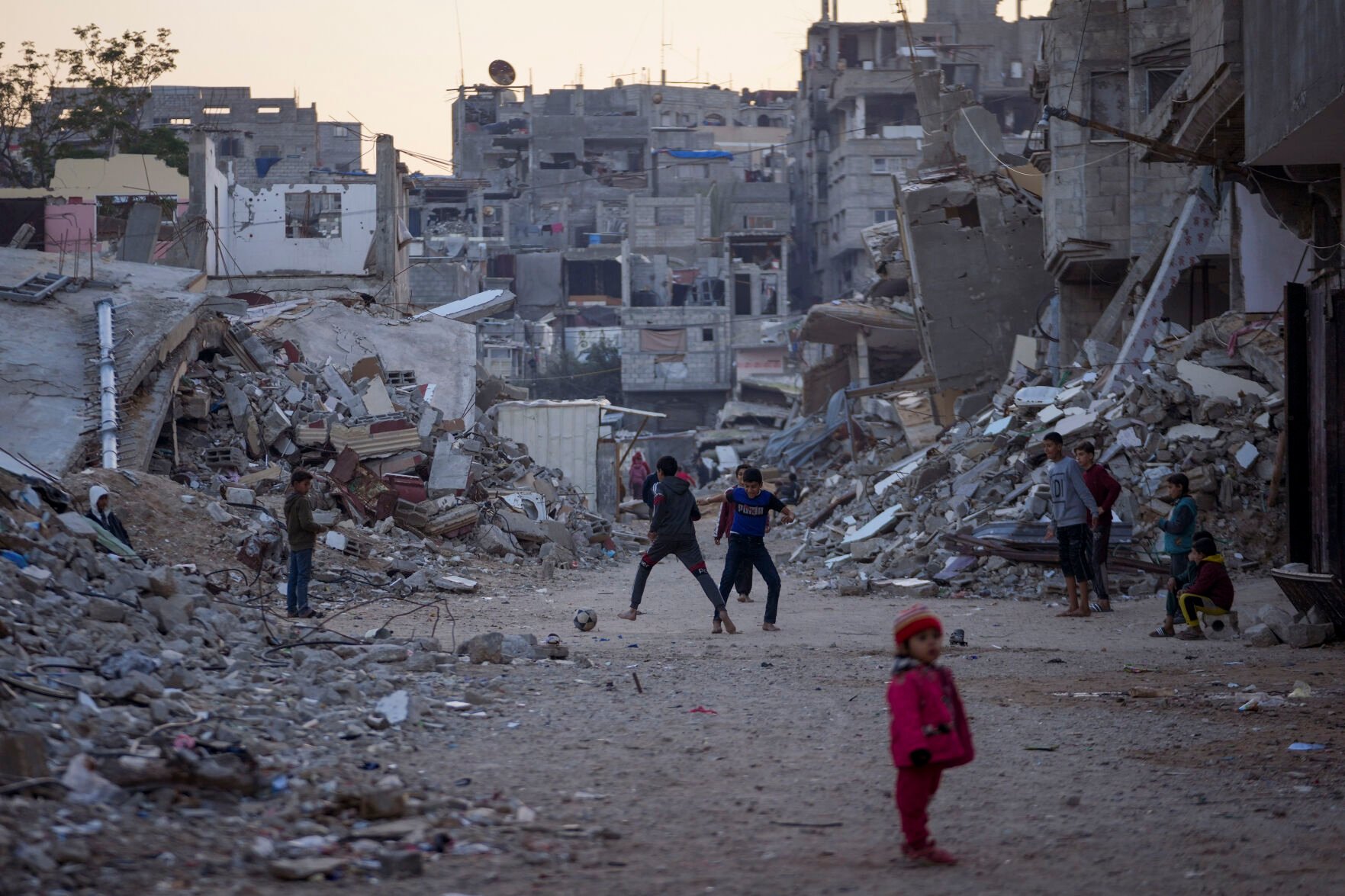 <p>FILE - Palestinian children play next to buildings destroyed by Israeli army strikes in Khan Younis, Gaza Strip, on Jan. 7, 2025. (AP Photo/Abdel Kareem Hana, File)</p>