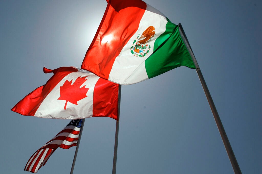 <p>FILE - National flags representing the United States, Canada, and Mexico fly in the breeze in New Orleans where leaders of the North American Free Trade Agreement met on April 21, 2008. (AP Photo/Judi Bottoni, File)</p>