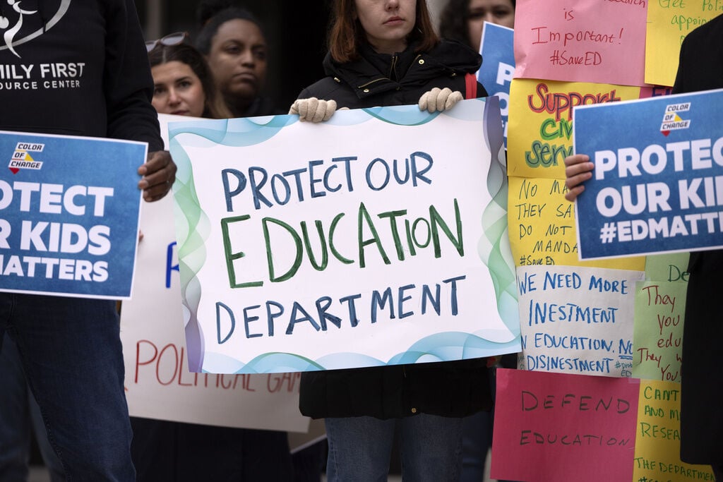 <p>Protestors gather during a demonstration at the headquarters of the Department of Education, Friday, March 14, 2025, in Washington. (AP Photo/Mark Schiefelbein)</p>