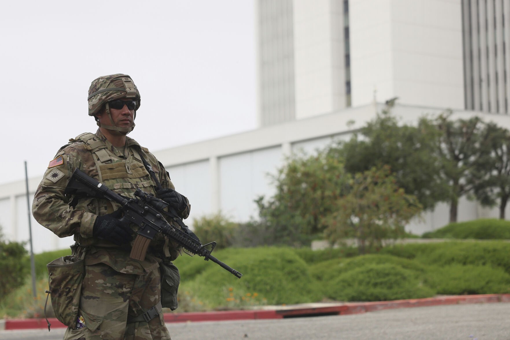 <p>A member of the National Guard stands outside the Wilshire Federal Building on Thursday in Los Angeles. </p>