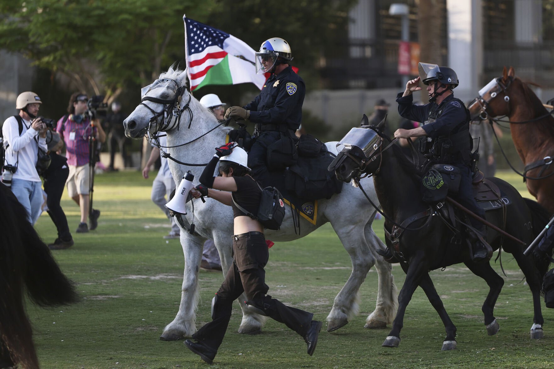 <p>Los Angeles Metro police on horseback charge protesters Wednesday in Los Angeles. </p>