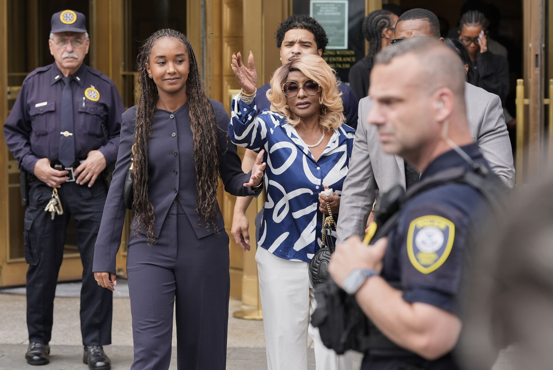 <p>Janice Combs, right, mother of Sean "Diddy" Combs, reacts outside Manhattan federal court after Combs' was convicted of a prostitution-related offense but acquitted on the most serious charges at his New York trial, July 2, in New York.</p>