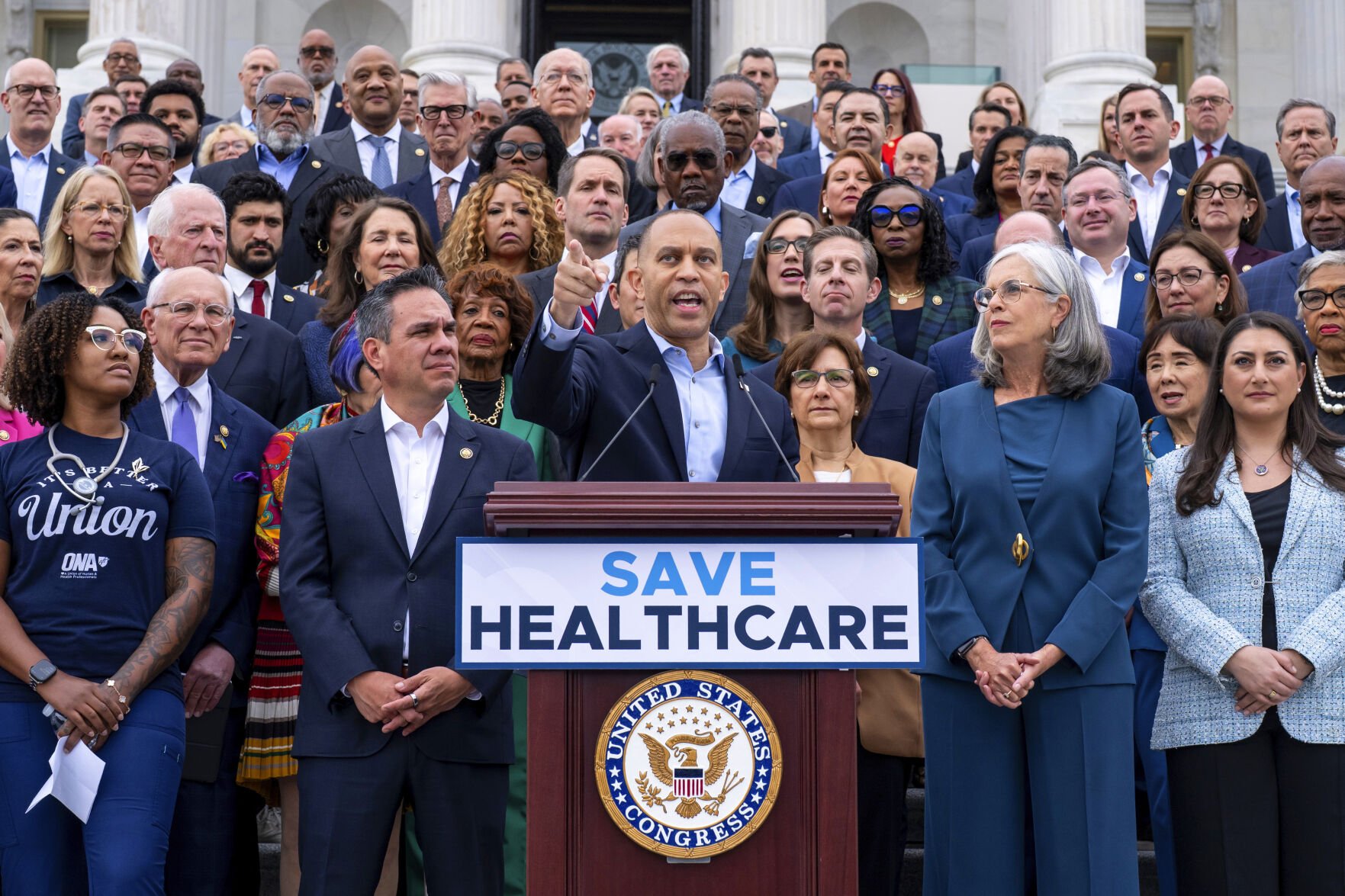 <p>House Minority Leader Hakeem Jeffries, D-N.Y., center, flanked by Rep. Pete Aguilar, D-Calif., left, and Rep. Katherine Clark, D-Mass., speaks Tuesday on the steps of the Capitol in Washington, insisting that Republicans include an extension of expiring health care benefits as part of a government funding compromise.</p>
