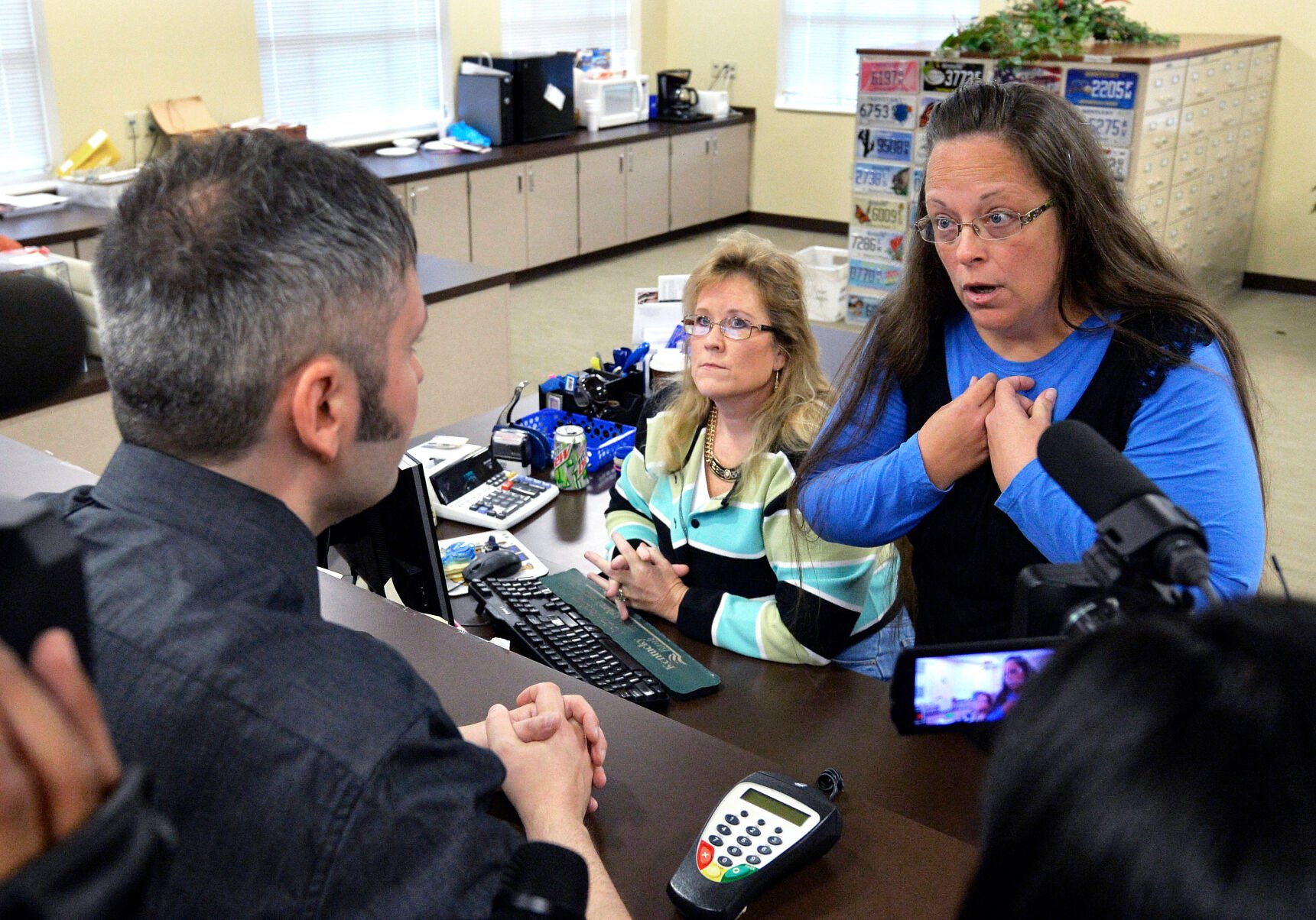 <p>Rowan County Clerk Kim Davis, right, talks with David Moore following her office's refusal to issue marriage licenses at the Rowan County Courthouse in Morehead, Ky., Sept. 1, 2015.</p>