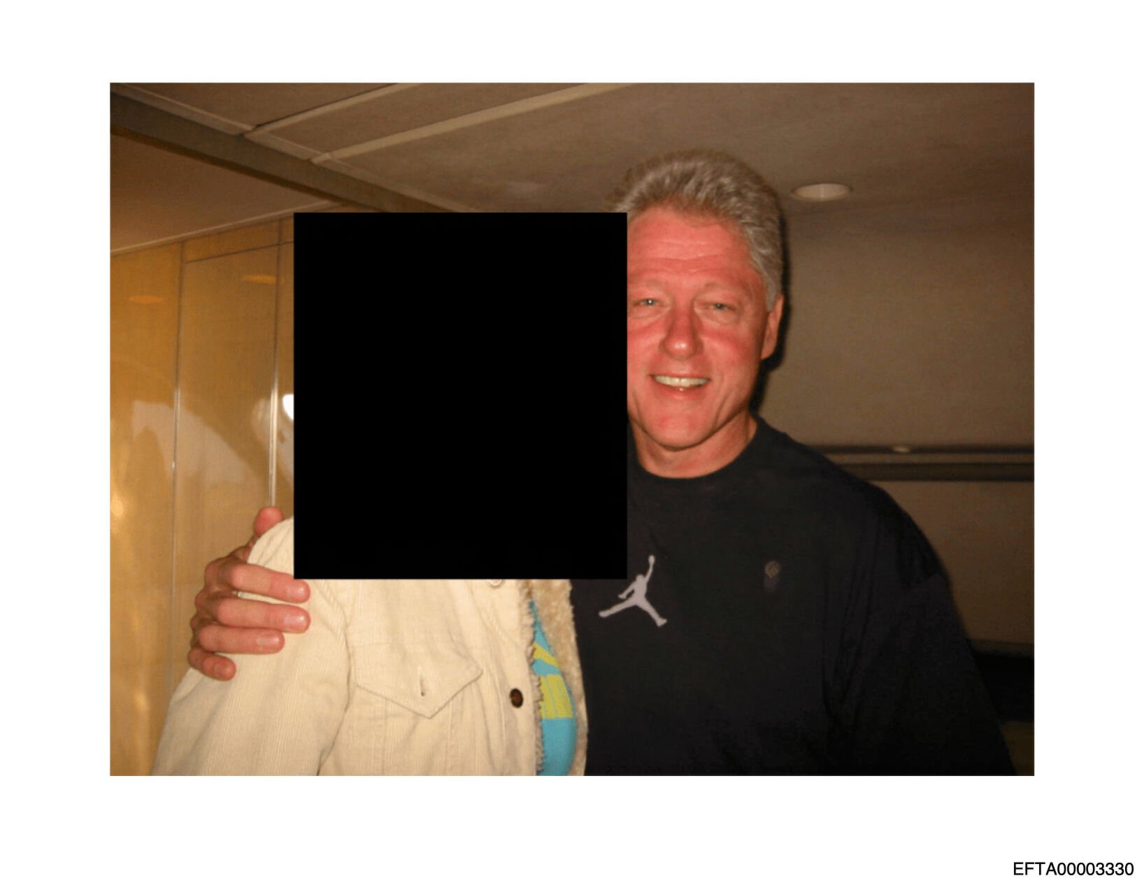 <p>This undated, redacted photo released by the U.S. Department of Justice shows former President Bill Clinton with an unknown person. (U.S. Department of Justice via AP)</p>
