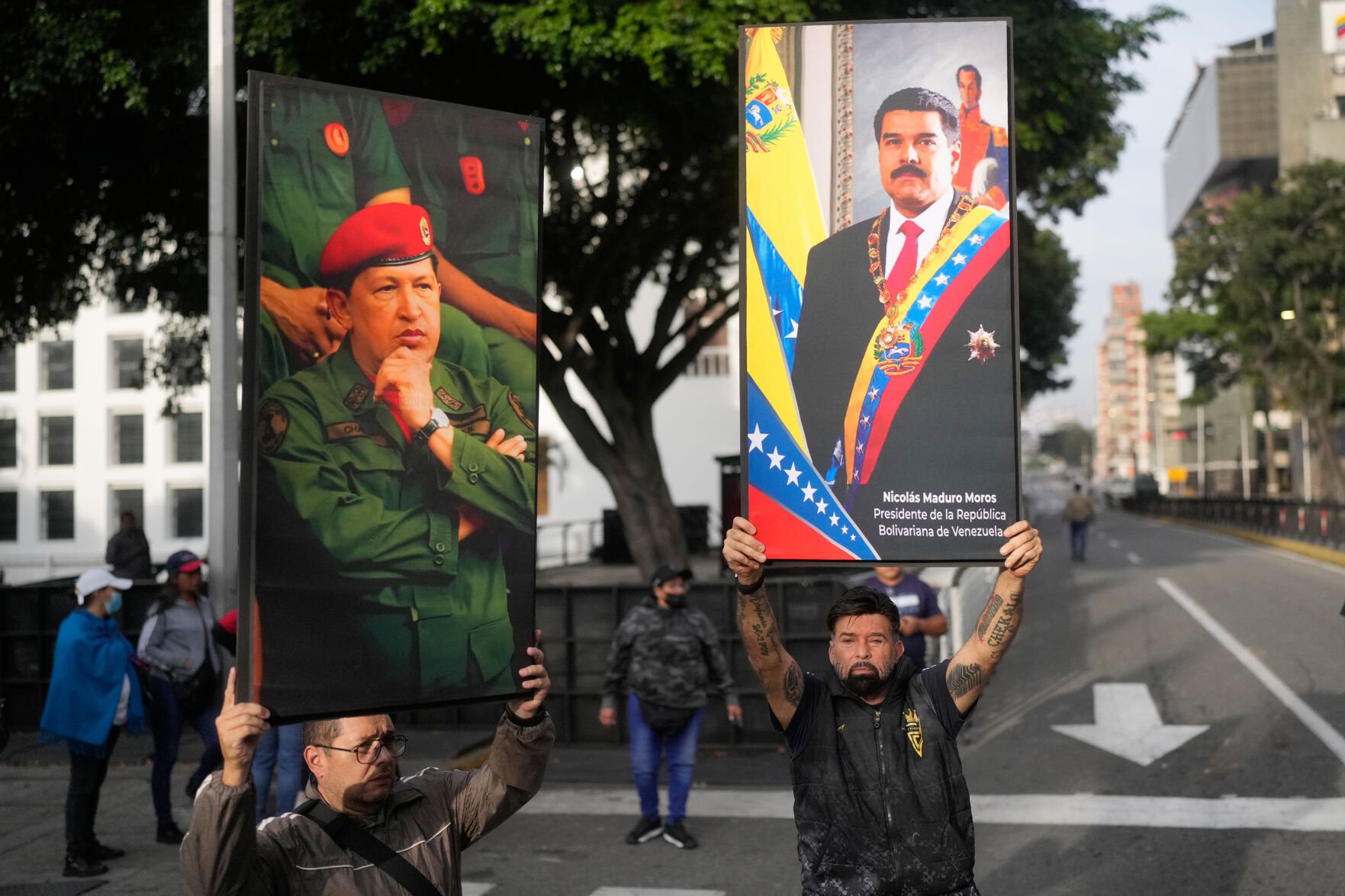 <p>Government supporters display posters of Venezuelan President Nicolás Maduro, right, and former President Hugo Chávez in downtown Caracas, Venezuela, Saturday, Jan. 3, 2026, after U.S. President Donald Trump announced that Maduro had been captured and flown out of the country.</p>