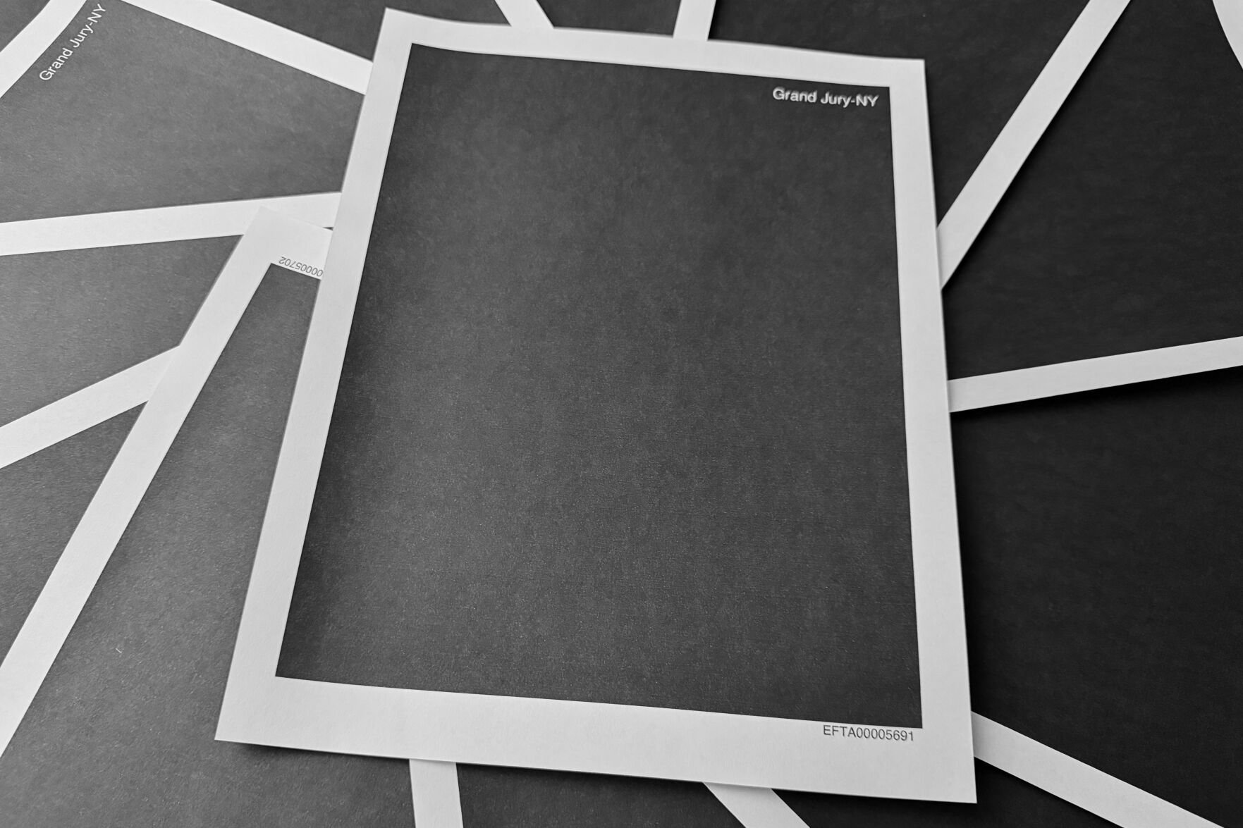 <p>Pages from a completely redacted New York grand jury file into Jeffrey Epstein and Ghislaine Maxwell, released by the U.S. Justice Department, are photographed Dec. 19 in Washington.&nbsp;</p>