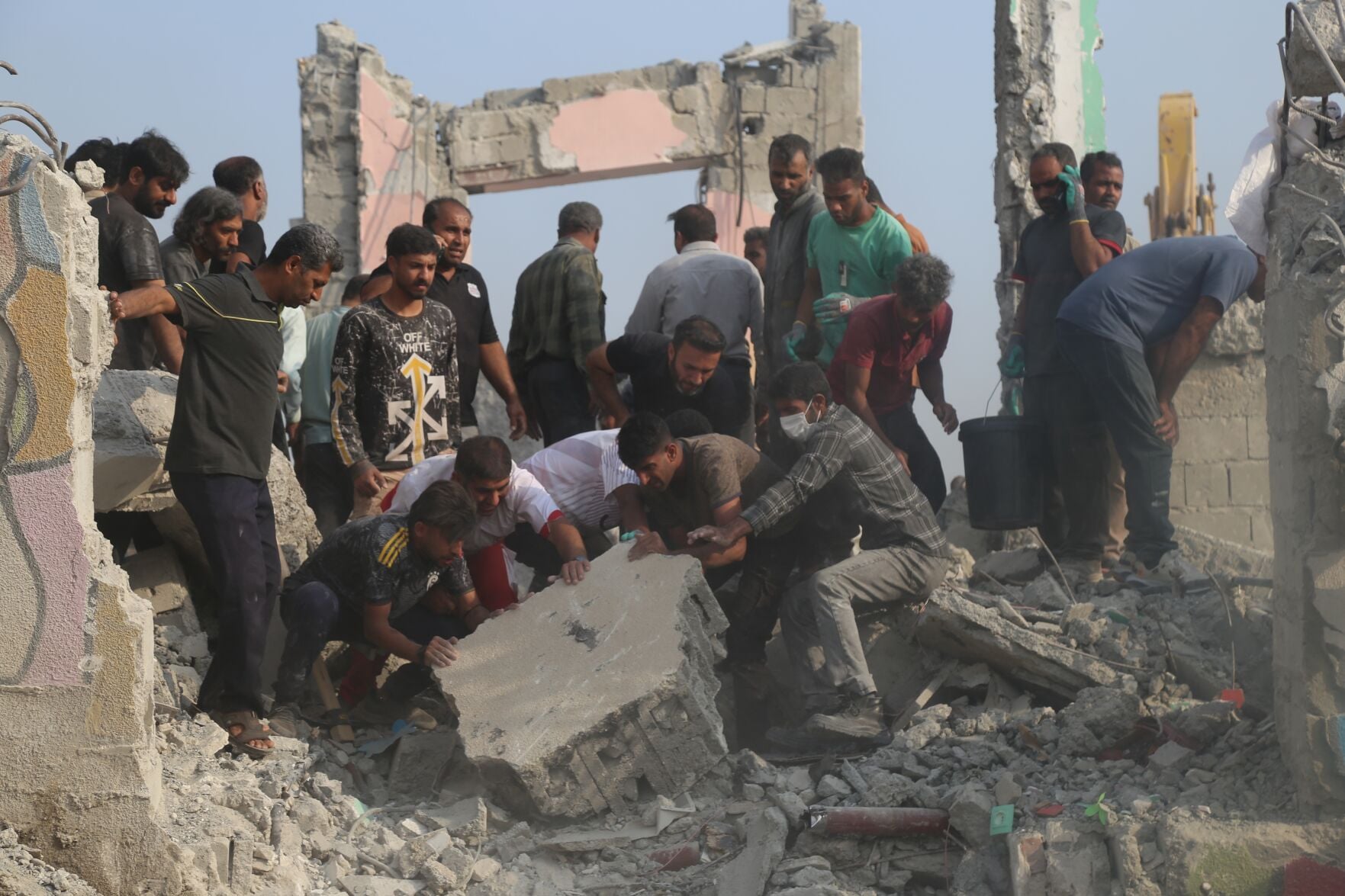 <p>Rescue workers and residents search through rubble Saturday in the aftermath of an Israeli-U.S. strike on a girls' elementary school in Minab, Iran.</p>