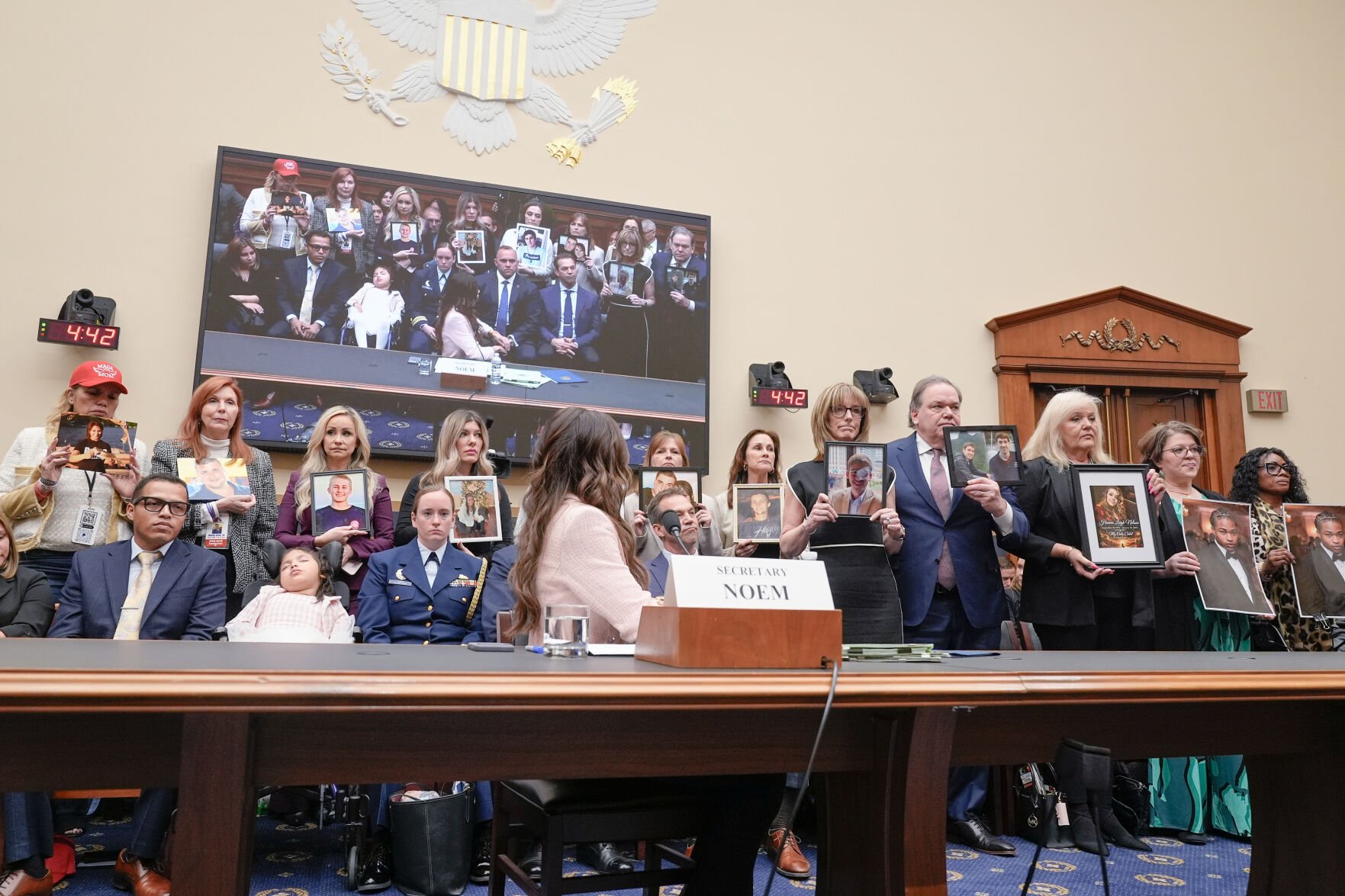 <p>Homeland Security Secretary Kristi Noem looks on as family members of victims stand during a House Committee on the Judiciary oversight hearing of the Department of Homeland Security on Capitol Hill, Wednesday, March 4, 2026, in Washington. (AP Photo/Mariam Zuhaib)</p>