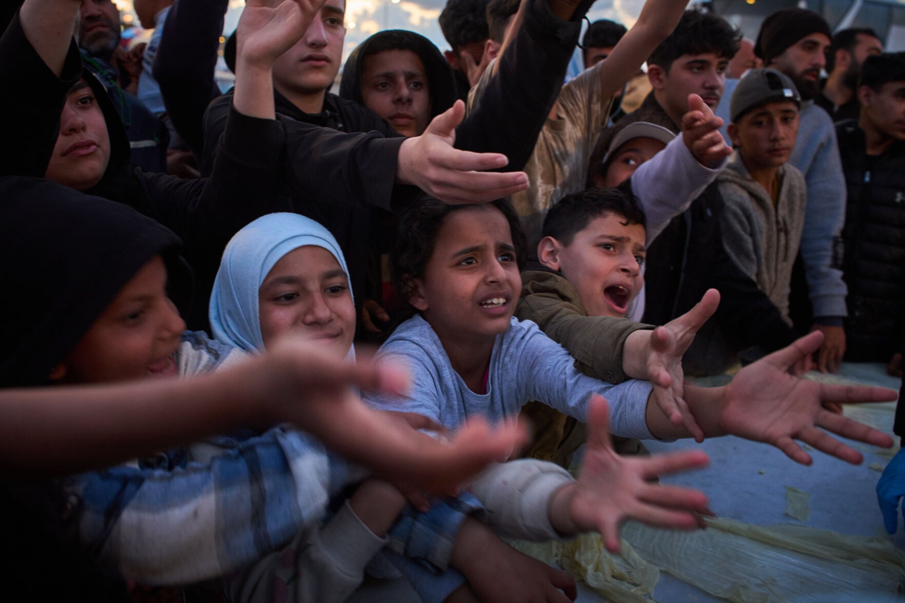 <p>Displaced people wait to receive donated food Monday beside the tents they use as shelters after fleeing Israeli bombardment in southern Lebanon, in Beirut, Lebanon. </p>
