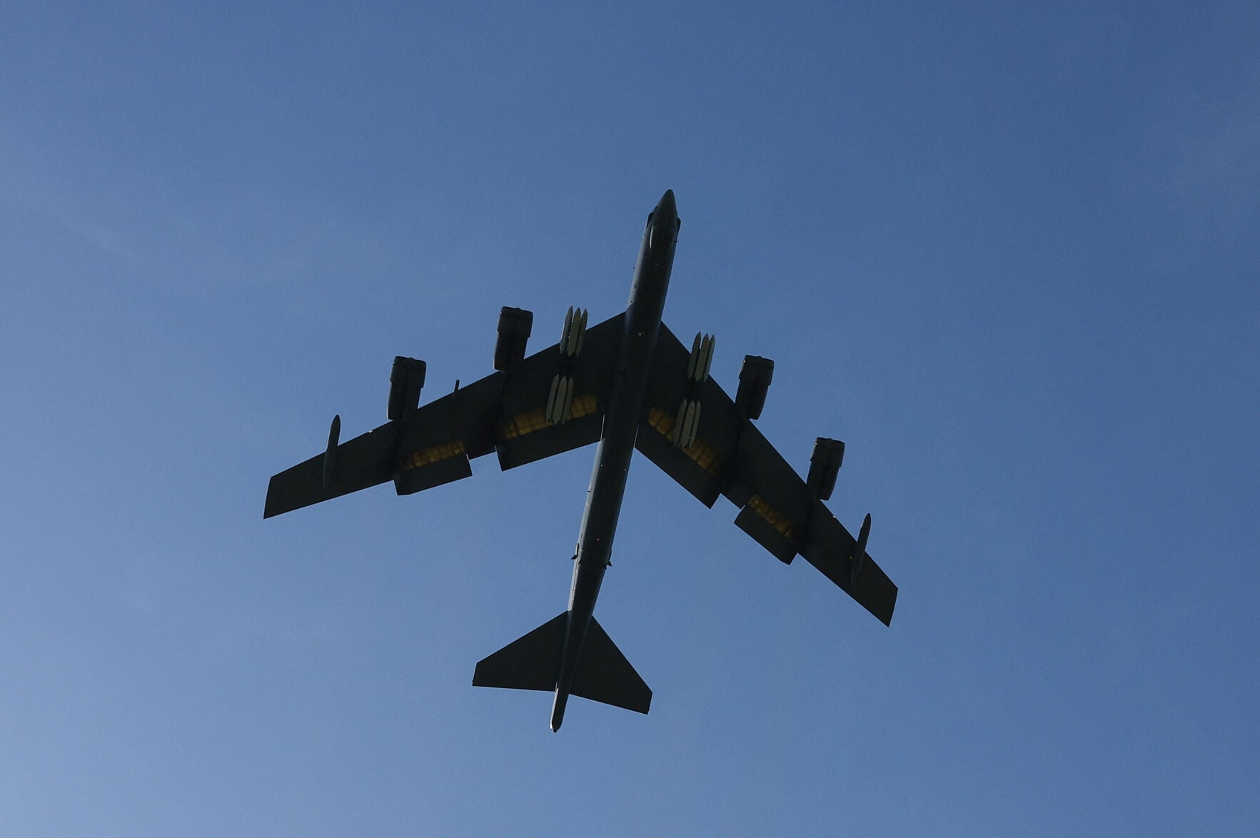 <p>A United States Air Force B-52 Stratofortress bomber loaded with munitions flies from RAF Fairford airbase in Fairford, Gloucestershire, Britain. </p>