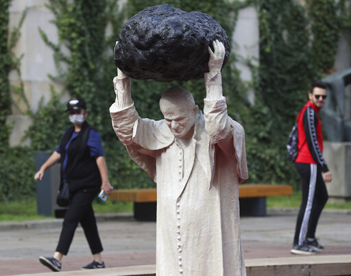 Sculpture Of John Paul Ii With Rock, Red Water Makes Waves