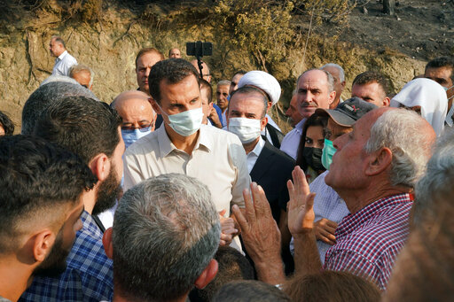 Assad Makes Rare Visit To Areas Hit By Fires In West Syria