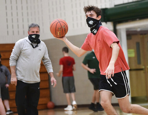 The Latest: Houston Hoops Paused; Michigan Gets New Opponent