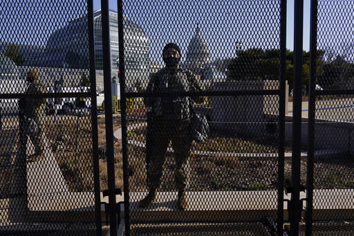 The Latest: Guard, Police At Capitol Fence; Mall Deserted