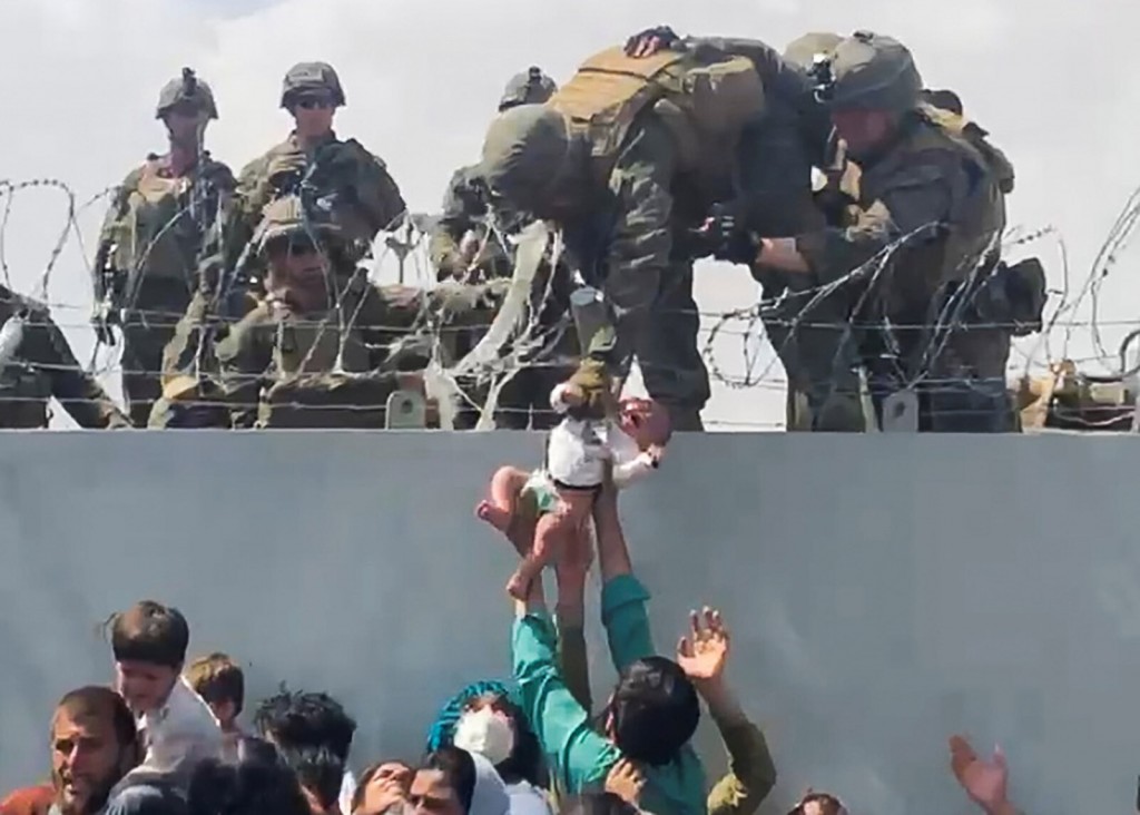 Fact Check: Did The Marine Who Trump Brought On Stage At Rally Actually Hoist A Baby Over A Wall At Kabul Airport?